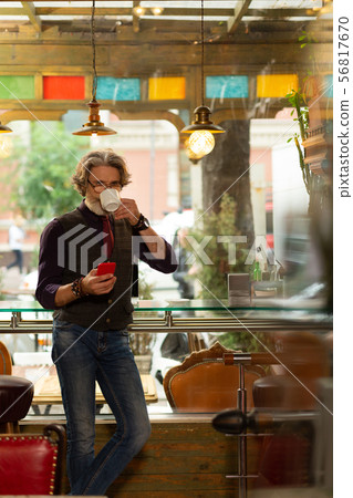 Thoughtful man drinking his coffee in the cafe. 56817670