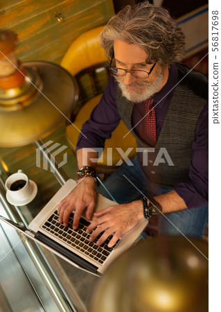 Man thinking what else to write in his article. 56817698