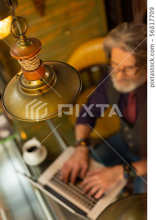 Man working in a cafe with specific interior. 56817709