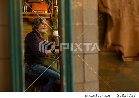 Happy man enjoying a cup of flavored coffee. 56817738