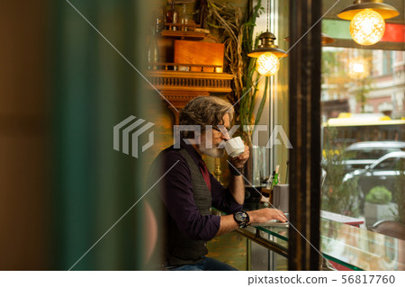 Man drinking coffee and thinking of work. Man drinking coffee and thinking of work. 56817760