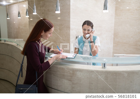 Woman filling in the form for dentist before examination 56818101