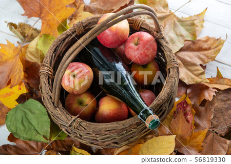 beautiful apples and bottle of cider, on autumn 56819330