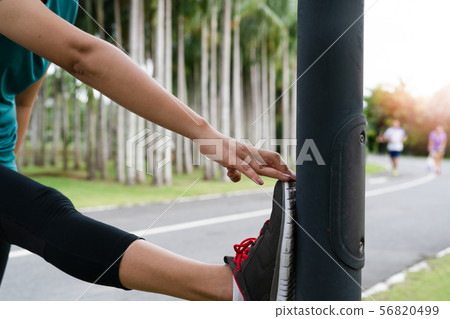 sport woman is stretching muscle before workout 56820499