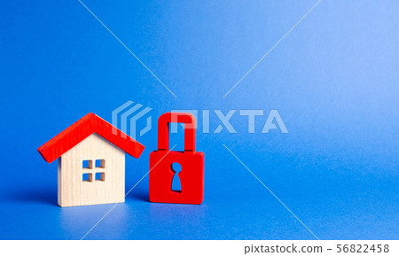 House figurine and a red padlock.  56822458