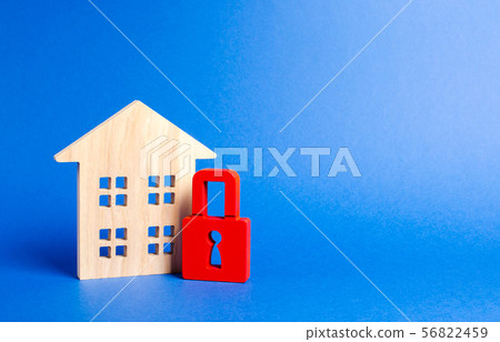 Wooden house and a red padlock. Security  56822459