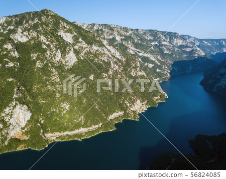 Aerial photo of a long winding road on Piva Lake in Montenegro Aerial photo of a long winding road on Piva Lake in Montenegro 56824085