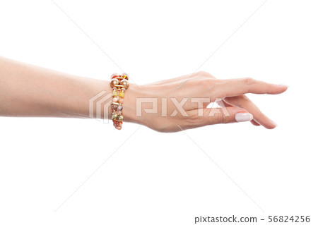 Hand in jewelry bracelet with opal, amber, jasper 56824256