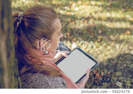 Real businesswoman with tablet laptop at work 56824278