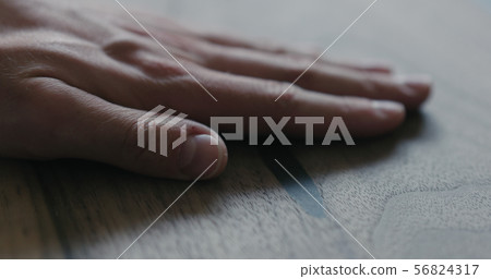 closeup man hand checking untrated black walnut solid board 56824317