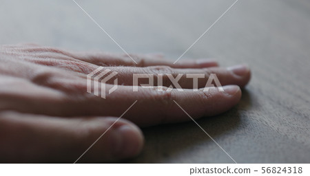 closeup man hand checking untrated black walnut solid board closeup man hand checking untrated black walnut solid board 56824318