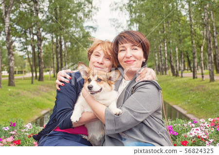 Happy female family with dog pet outdoor 56824325