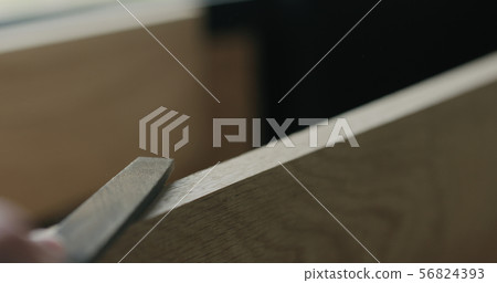 closeup man hand sandig oak board edge with file 56824393