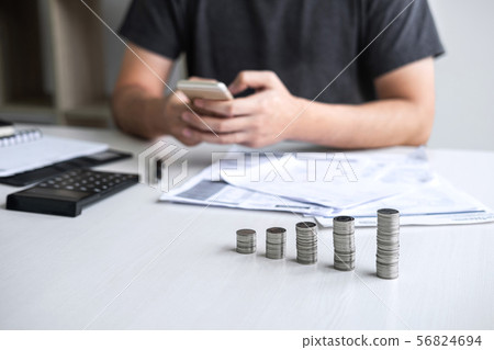 Images of stacking coin pile and Husband using Images of stacking coin pile and Husband using 56824694
