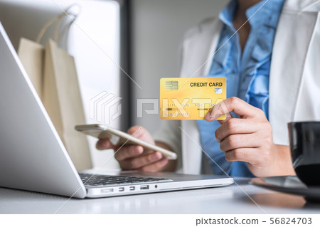 Young woman consumer holding smartphone, credit Young woman consumer holding smartphone, credit 56824703
