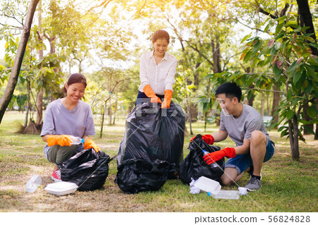 Young Asian people collecting trash in garbage bag in the park 56824828