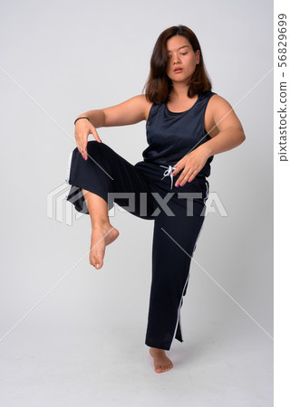 Young beautiful Asian woman dancing and standing on one leg 56829699