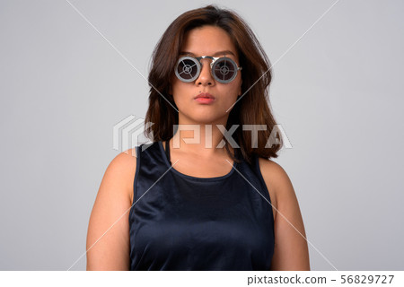 Portrait of young beautiful Asian woman wearing sunglasses with target design 56829727