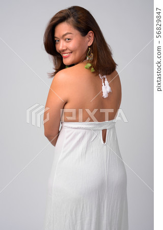 Rear view of young happy Asian woman smiling ready for summer Rear view of young happy Asian woman smiling ready for summer 56829847