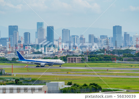 Osaka cityscape and airplane Osaka (Itami) airport 56830039