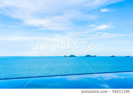 Beautiful outdoor swimming pool with sea ocean on white cloud blue sky background Beautiful outdoor swimming pool with sea ocean on white cloud blue sky background 56831190