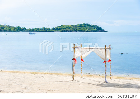 Beautiful outdoor tropical beach sea ocean with umbrella chair and lounge deck around there on white cloud blue sky Beautiful outdoor tropical beach sea ocean with umbrella chair and lounge deck around there on white cloud blue sky 56831197