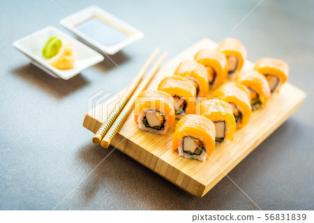 Salmon fish meat sushi roll maki on wood plate 56831839