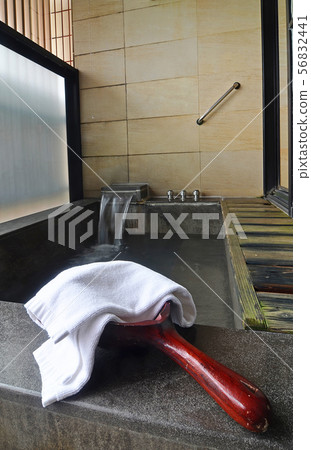 Wooden water scoop with a towel  56832441