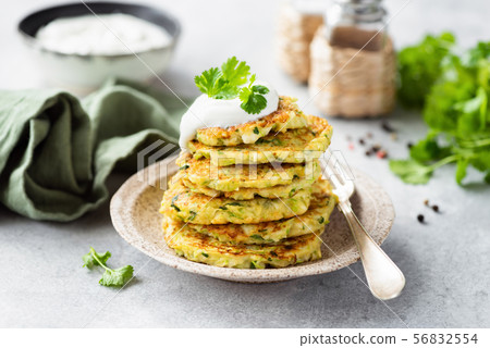Vegetarian zucchini fritters with sour cream and cilantro Vegetarian zucchini fritters with sour cream and cilantro 56832554