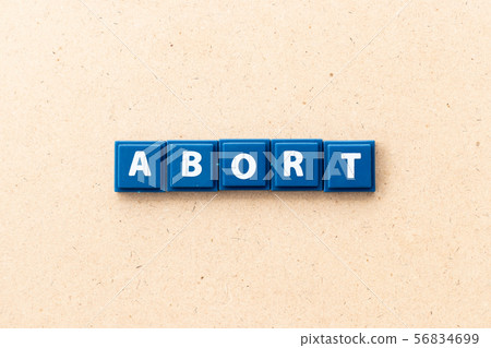 Tile letter in word abort on wood background 56834699