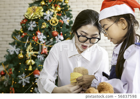 Mother play with her daughter with teddy bear on Mother play with her daughter with teddy bear on 56837598