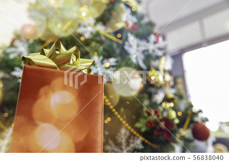 Christmas gift box on tree background with copy Christmas gift box on tree background with copy 56838040