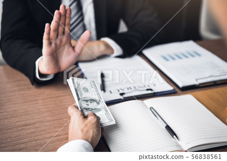 Business person refusing bribe given money by Business person refusing bribe given money by 56838561