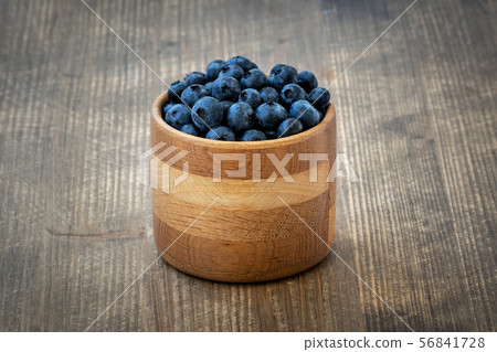 Freshly picked blueberries in wooden bowl 56841728