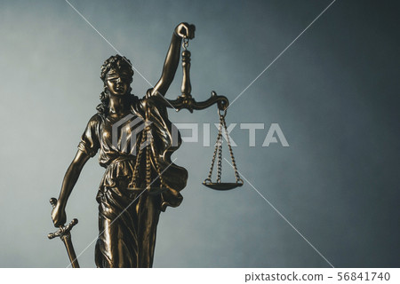Brass statue of Justice holding scales and sword 56841740