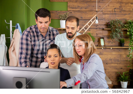 Group of creative people brainstorming in front of PC screen 56842967