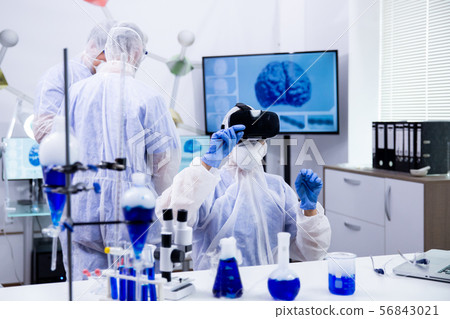 Female scientist using virtual reality simulation for scientific research 56843021