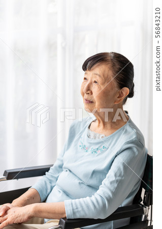 Senior woman in a wheelchair (vertical composition) 56843210