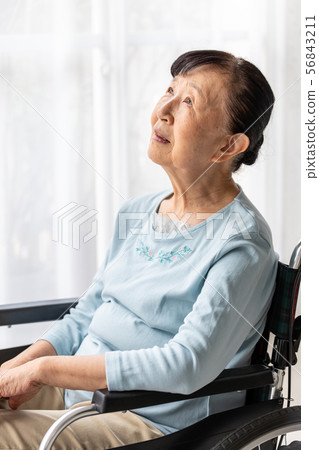 Senior woman in a wheelchair (vertical composition) 56843211