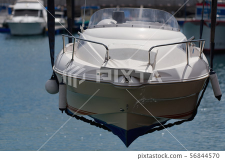 White boat is rising from the sea by using crane White boat is rising from the sea by using crane 56844570