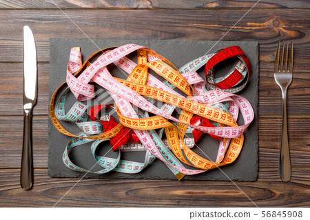 Top view of heap of colorful measuring tapes in 56845908