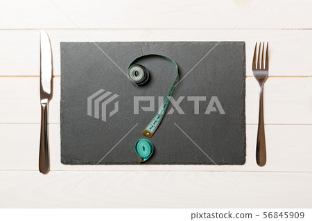 Top view of slate plate, fork and measure tape in 56845909