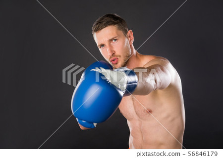 Sportsman boxer fighting in gloves on the black background. 56846179