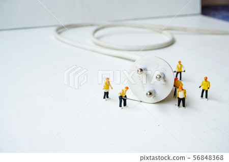 miniature electronic technician working to connect miniature electronic technician working to connect 56848368