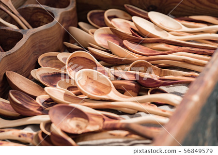 Many large wooden spoons 56849579