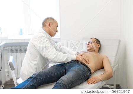 Doctor physiotherapist examining his patients Doctor physiotherapist examining his patients 56851947