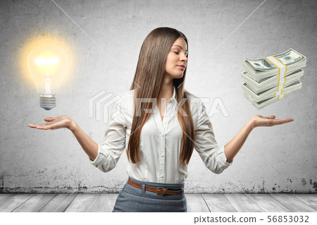 Crop image of young beautiful businesswoman, hands at sides, palms facing up and levitating Crop image of young beautiful businesswoman, hands at sides, palms facing up and levitating 56853032