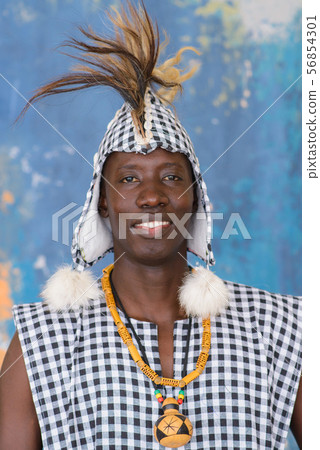 African artist in traditional clothes playing djembe drum African artist in traditional clothes playing djembe drum 56854301