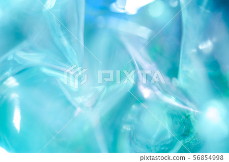 Holographic background in the style of the 80-90s. Real texture of cellophane film in bright acid Holographic background in the style of the 80-90s. Real texture of cellophane film in bright acid 56854998