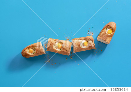 Bread loaf with baked eggs. Food portions 56855614